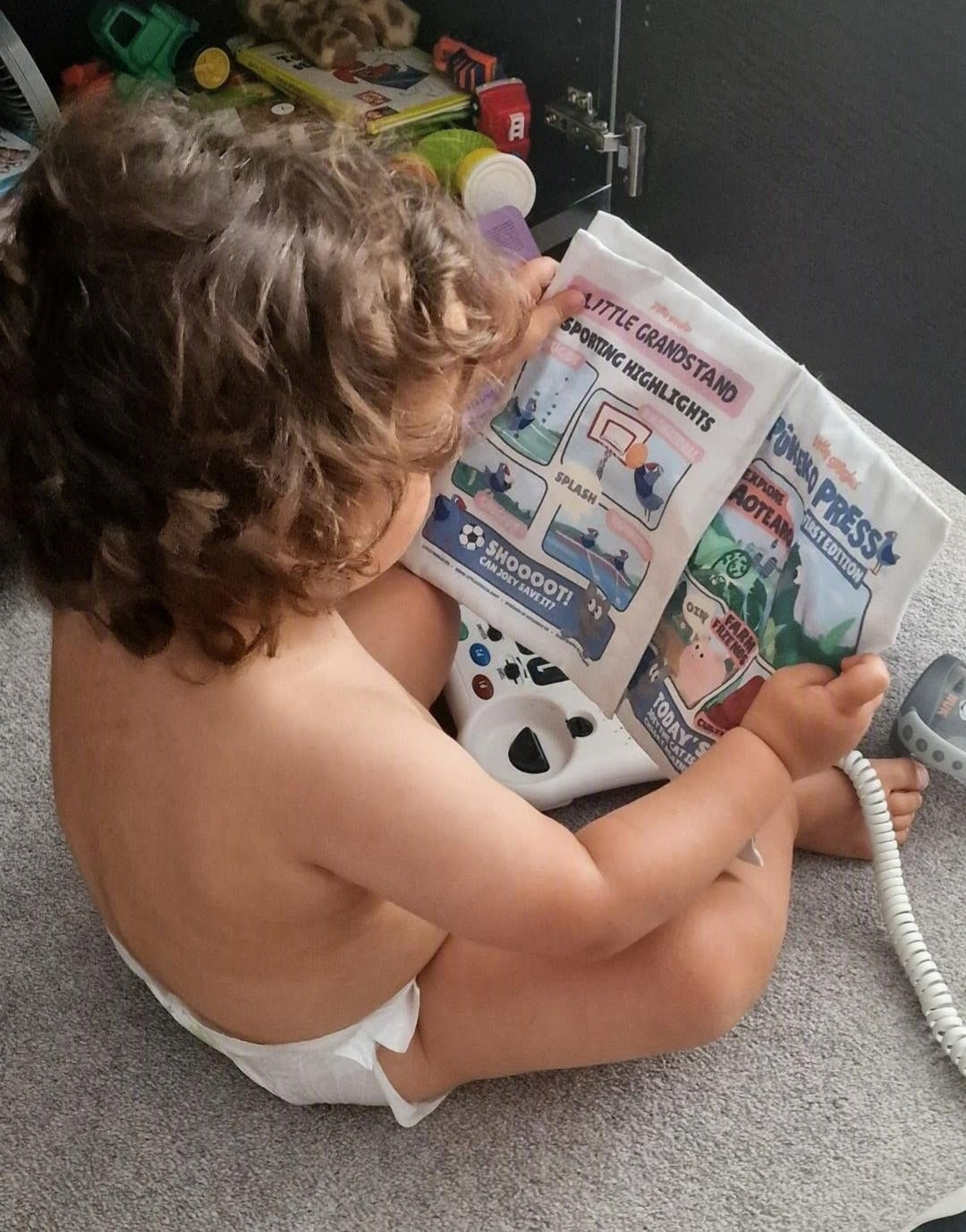 Child exploring Pūkeko Press baby sensory toy during play